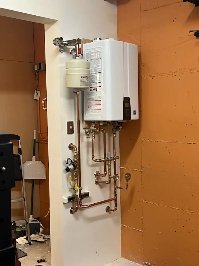 Plumbing technician inspecting water heater connections in Opa-locka